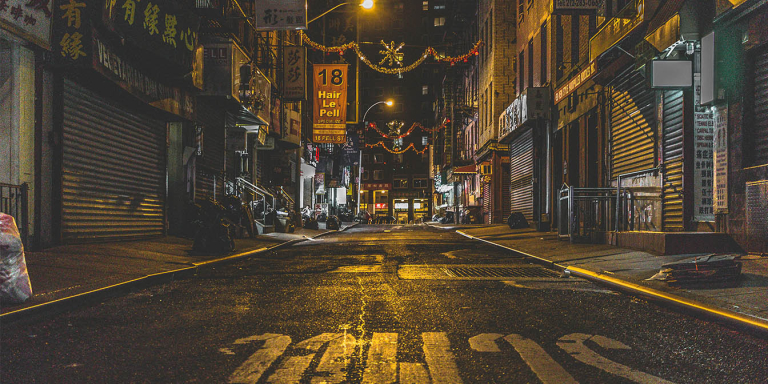 A street in New York shot from a crosswalk during night-time